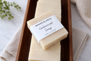 Cedarwood Soap bar, labeled on a stack of other cedarwood soap bars inside of a wooden tray