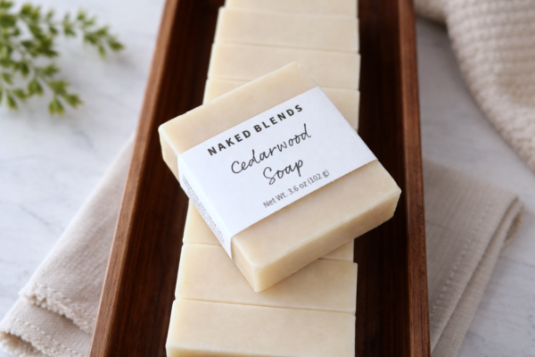 Cedarwood Soap bar, labeled on a stack of other cedarwood soap bars inside of a wooden tray