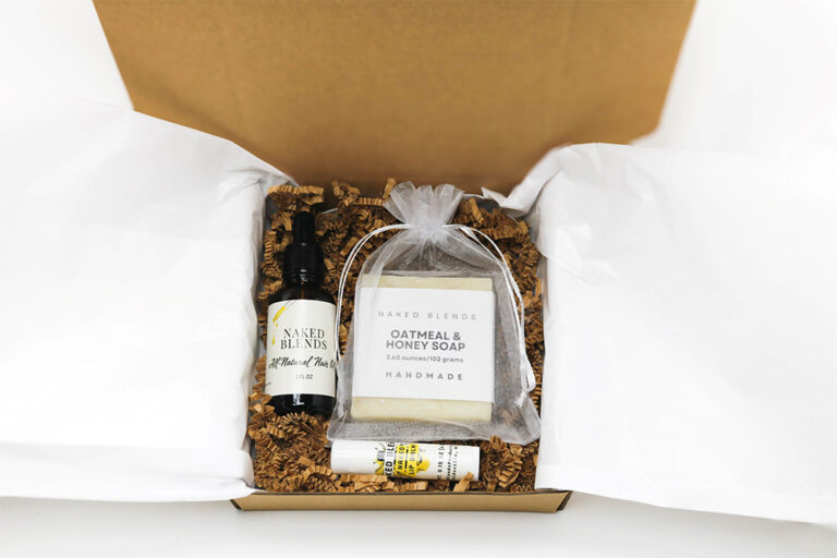 Body and Hair Care Set with soap, hair oil, and lip balm in a box with tissue and crinkle paper