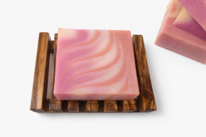Sunset Serenity Soap bar with peach, purple, and white swirls, one on wooden soap dish