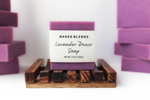 Lavender Dance Soap, labeled and resting on a wooden soap dish in