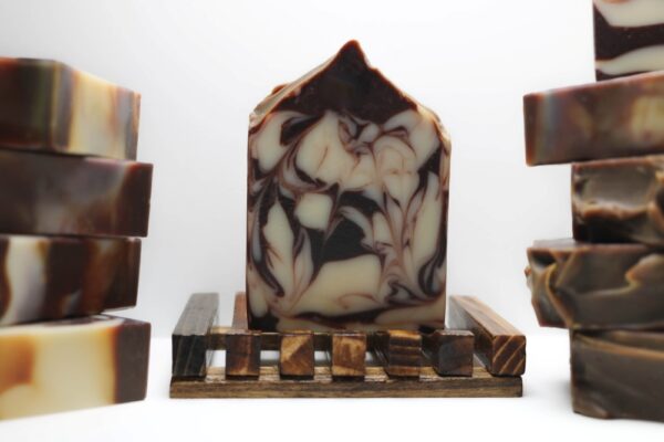 Mintwood Soap bar on a wooden soap dish with cocoa powder swirls, handmade and infused with clove bud, peppermint, eucalyptus, and cedarwood essential oils