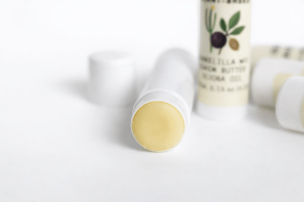 Naked Lip Balm Vegan Formula White Round Tubes with the lid off exposing the lip balm